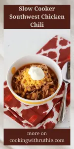 This slow cooker chicken chili combines the bold flavors of taco seasoning with tender chicken and creamy beans. It's a satisfying and easy-to-make meal that the whole family will love. Serve with avocado slices and crunchy tortilla chips for the ultimate comfort food experience. #ChickenChili #SlowCookerMeals #SouthwestCuisine #FamilyDinner #CookingWithRuthie