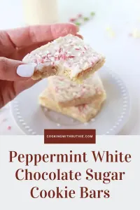 Soft sugar‑cookie bars swirled with sweet white chocolate and a peppermint twist &mdash; these festive bars are perfect for December cookie trays, cozy nights in, or holiday treat swaps. 🍬 | cookingwithruthie.com #peppermintsugarbars #holidaybaking #christmascookies #winterdesserts #whitechocolate #festivetreats #pinterestfood #cookingwithruthie