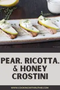 Crispy baguette slices topped with creamy ricotta, juicy pear slices and a drizzle of golden honey — this Pear‑Ricotta & Honey Crostini is the perfect simple yet chic appetizer for holiday gatherings, cozy December dinners, or festive brunches. 🍐🧀 | cookingwithruthie.com #holidayappetizers #crostini #winterbrunch #festivefood #ricottarecipes #holidayentertaining #pinterestfood #cookingwithruthie